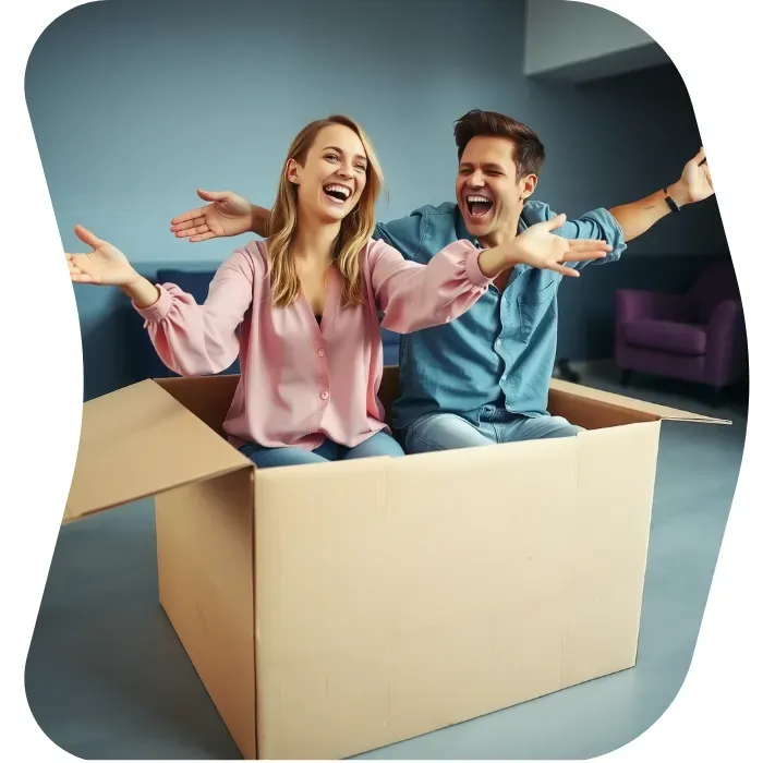 Two guys sitting on the floor of their apartment with Muval moving boxes